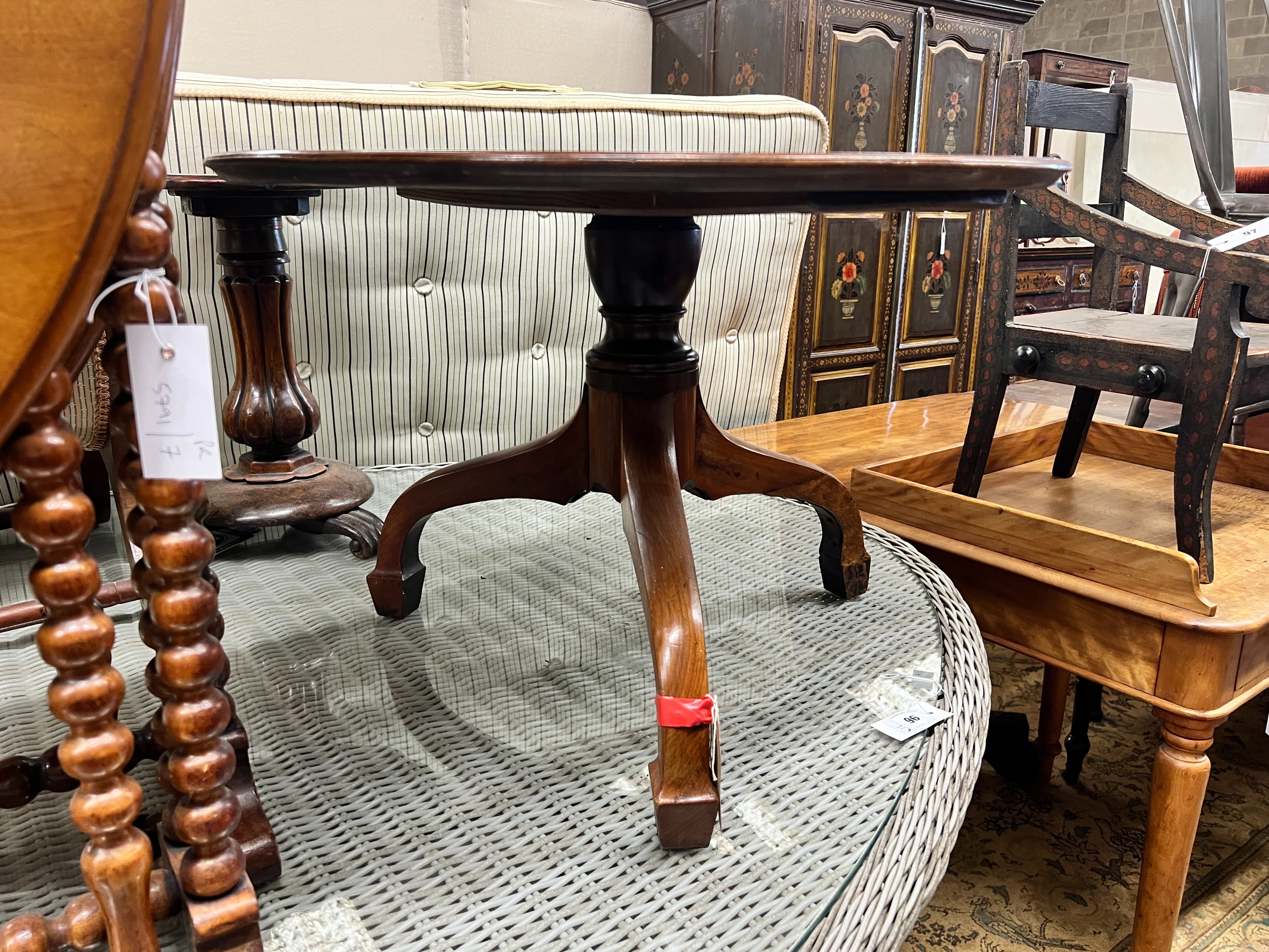 An early Victorian mahogany dish top tea table, diameter 69cm, height 47cm (cut down, converted from a dumb waiter) and a Victorian Sutherland table, width 55cm, depth 16cm, height 63cm